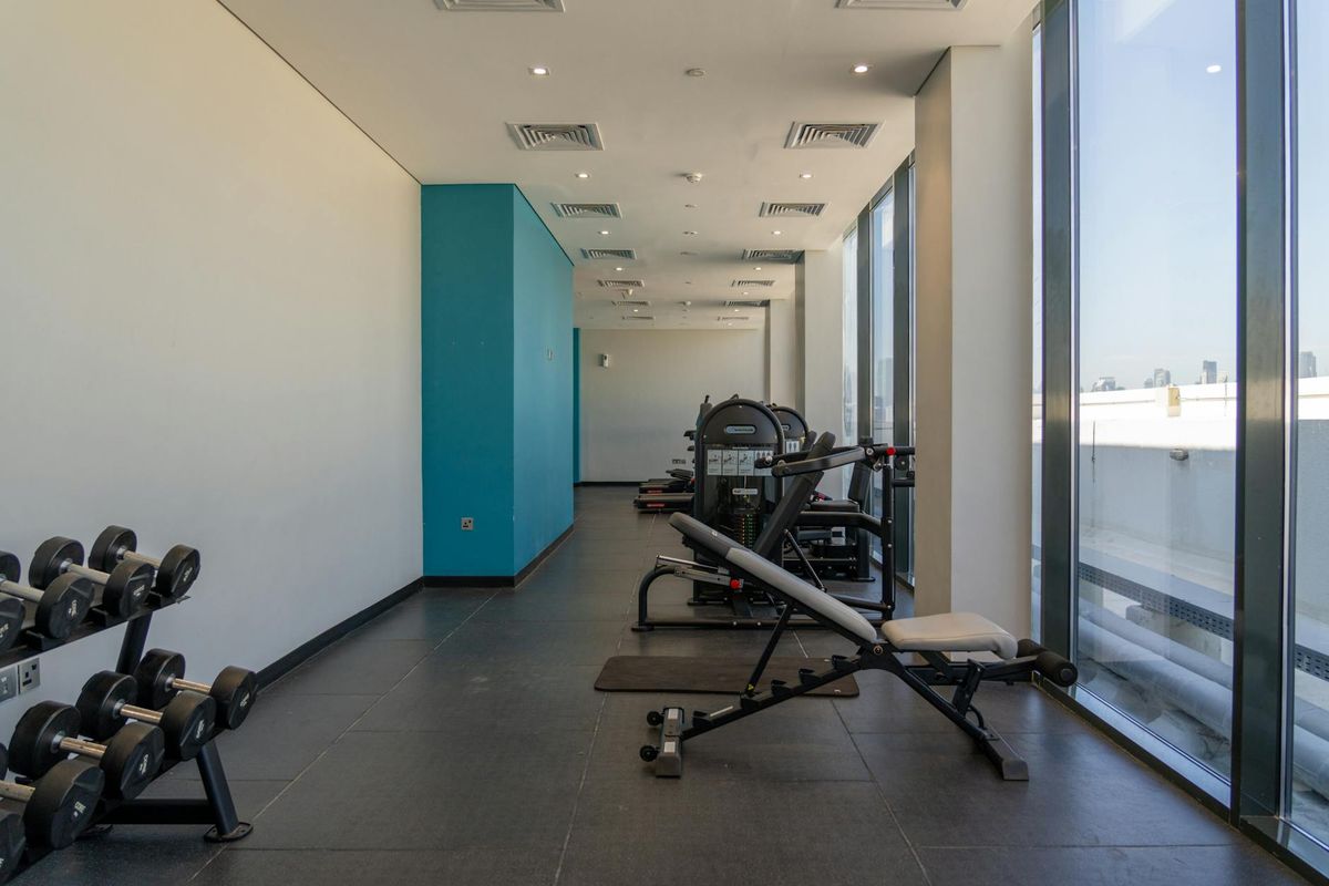 Atmospheric photo of a modern gym interior with green light