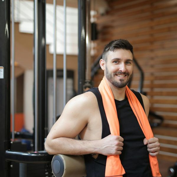 Man finishing his workout with a towel