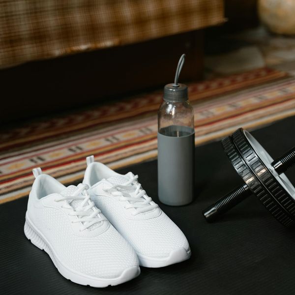 Sport shoes and water bottle on the floor